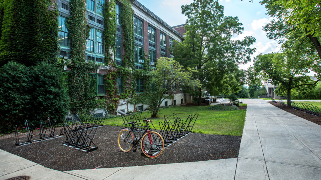 Empty school building with ivy and bike racks in front
